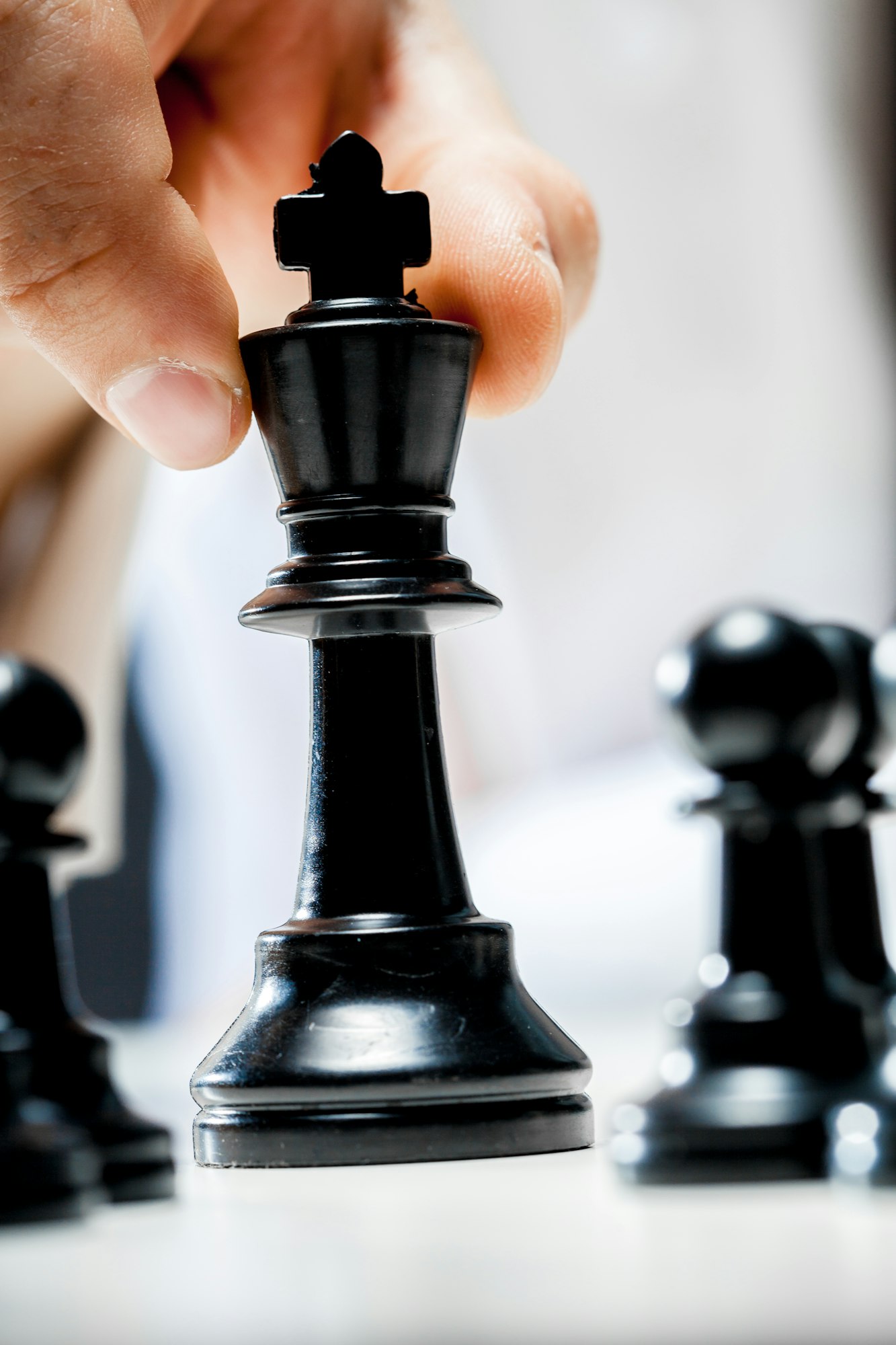 Hand of businessman playing chess